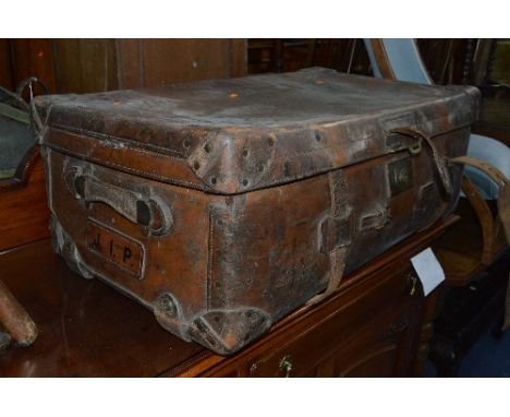 A VINTAGE LEATHER SUITCASE, stamped to side J.I.P, the interior red lined with label to inner lid reading, Made at the Societ