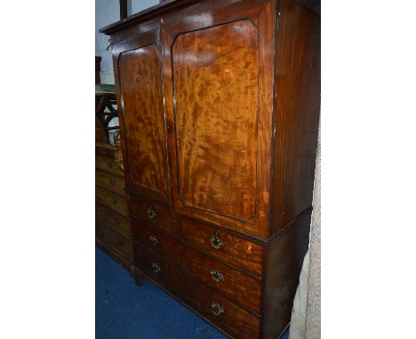 A GEORGIAN MAHOGANY LINEN PRESS, the double panelled doors revealing five pull out slides above two short and two long drawer