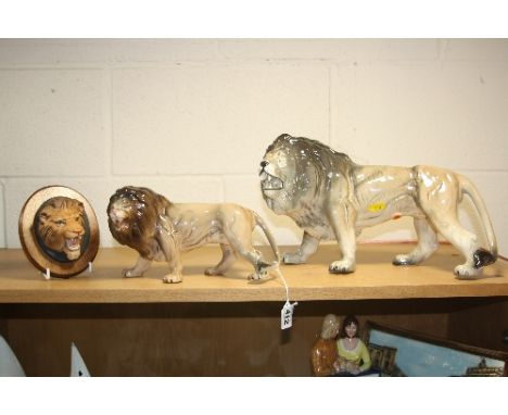 TWO MELBA WARE LIONS, largest length approximately 37cm and height 22cm and a Beswick 'Lion's Head' wall plaque No.2933 (3)