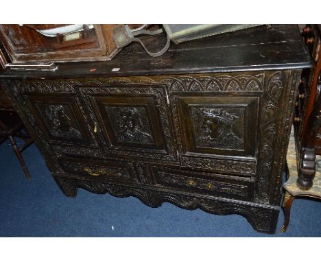 A LATE 17TH AND LATER CARVED OAK MULE CHEST, converted to a single door cupboard, triple panel front, carved with male and fe