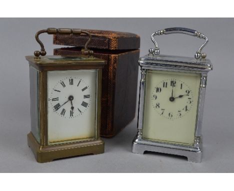 A BRASS CARRIAGE CLOCK, with it's travelling case and another carriage clock