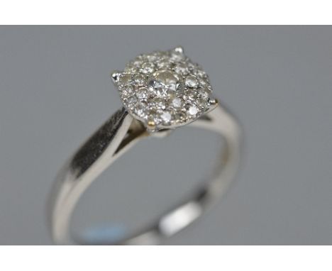 A MODERN ROUND DIAMOND CLUSTER RING, estimated total diamond weight 0.50ct, colour assessed as I-J, clarity assessed as L1, r