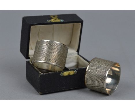 A BOXED PAIR OF SILVER NAPKIN RINGS