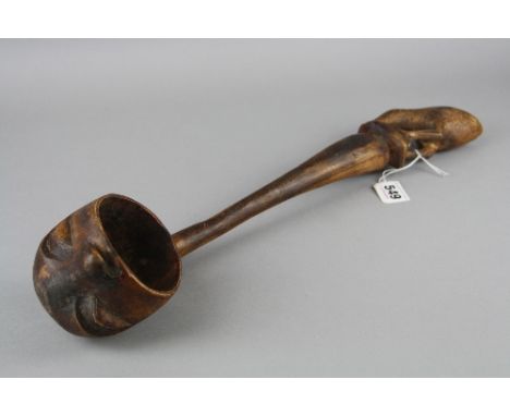 A CARVED TREEN LADLE, with Kiwi bird finial, the ladle bowl exterior carved as a head, length approximately 47cm 