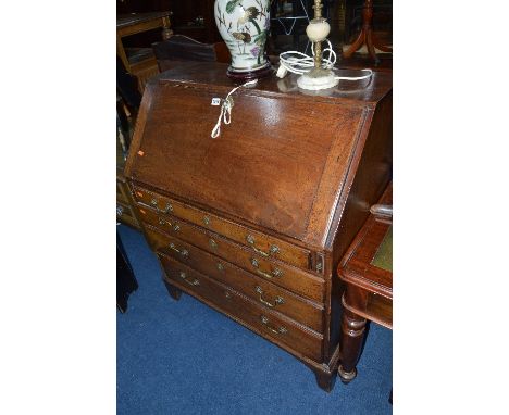 A GEORGIAN MAHOGANY FALL FRONT BUREAU, with fitted interior above four graduated drawers with brass swan neck handles, on bra