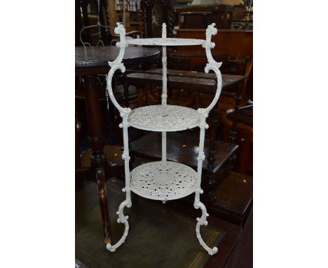 A PAINTED VICTORIAN CAST IRON THREE TIER STAND, with pierced foliate detail to each shelf joined by scrolled uprights, stampe