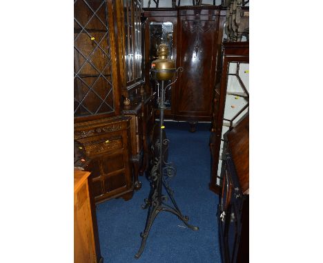 A WROUGHT IRON OIL LAMP, on triple legs, a brass log bucket and other brass items 