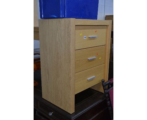 A LIGHT OAK FINISH CHEST, of three drawers, approximate size width 63cm x height 85cm x depth 45cm