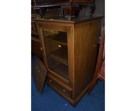 AN ERCOL GOLDEN DAWN GLAZED SINGLE DOOR CABINET, with adjustable shelving above a single drawer, approximate size width 56cm 