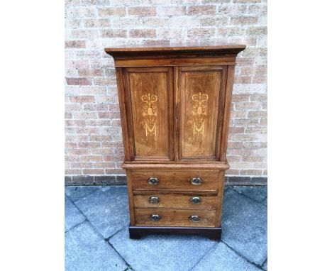 AN EDWARDIAN INLAID ROSEWOOD SIDE CABINET  with moulded frieze above pair of doors with marquetry inlaid decoration over thre