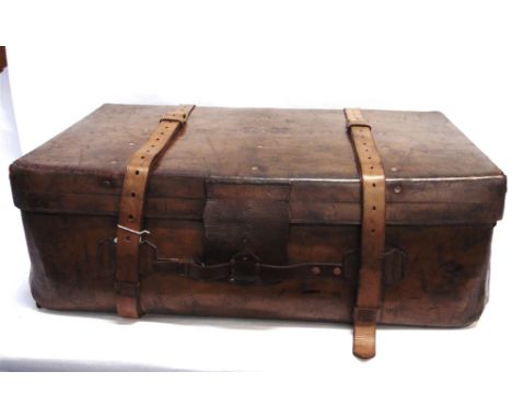 A RECTANGULAR LEATHER TRUNK  by Army and Navy, London, with pair of leather straps, brass corner, with two wooden stretcher o