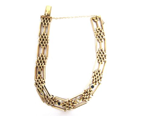 AN EDWARDIAN ROSE GOLD, SAPPHIRE AND DIAMOND BRACELET  in the form of alternate lozenge-cluster blocks and three-bar gate lin