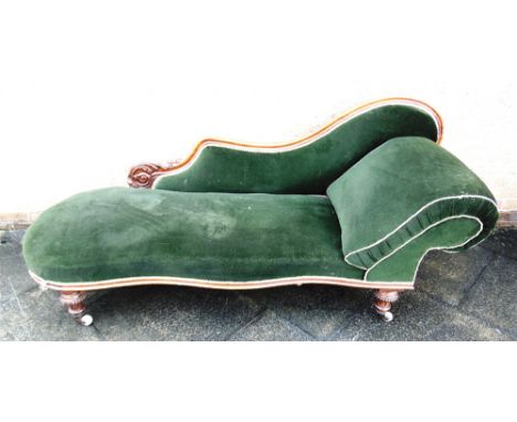 A VICTORIAN CARVED WALNUT FRAMED CHAISE LONGUE  on turned and fluted supports with ceramic casters, 198cm long