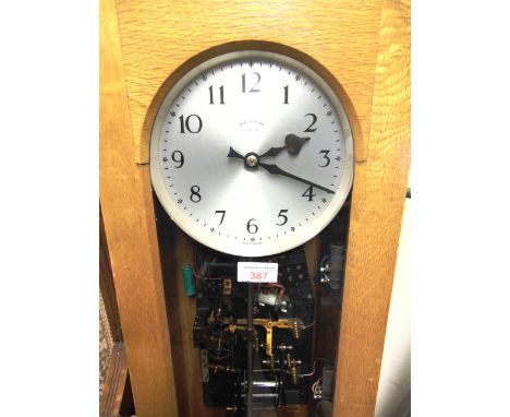 A SYNCHRONOME ELECTRIC MASTER CLOCK  in light oak case, the silvered dial inscribed 'SYNCHRONOME LONDON', with weight and pen