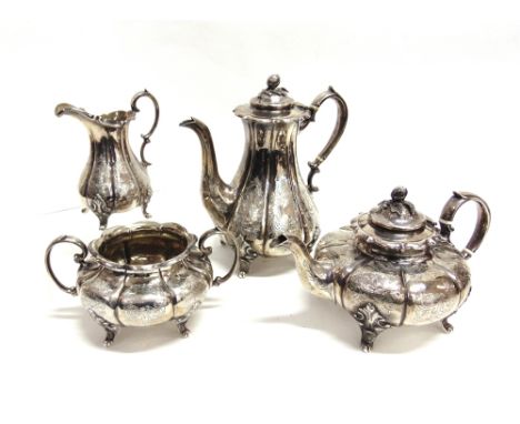 A VICTORIAN SILVER MELON FLUTED FOUR PIECE TEA SERVICE each engraved with foliate scrolls in panels and vacant cartouches, wi