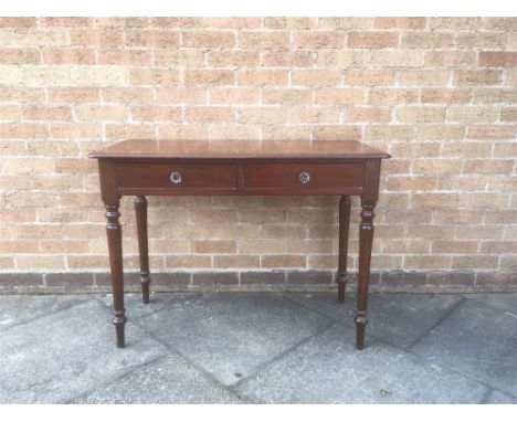 A VICTORIAN MAHOGANY SIDE TABLE  with two frieze drawers with glass handles, on turned supports, 101cm wide