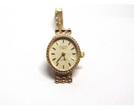 ROTARY, A LADY'S 9CT GOLD OVAL BRACELET WATCH circa 1985, the oval silver and gold trellis-pattern dial with raised baton num