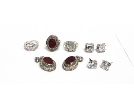 A GROUP OF GEM SET DRESS JEWELLEY comprising; a glass-filled-ruby and cubic zirconia oval cluster ring and a pair of matching