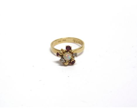 A MODERN 18CT GOLD, RUBY, OPAL AND DIAMOND ABSTRACT CLUSTER RING the central round cabochon white opal displays a pleasing pl