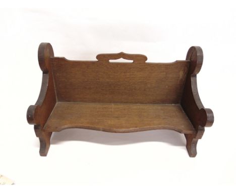 AN OAK BOOK TROUGH  with carved roundel decoration to each end, 49cm wide