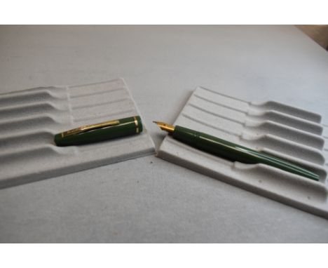 A Burnham vacuum fill fountain pen in green with single band to the cap having Osmiroid nib. Approx 13.3cm