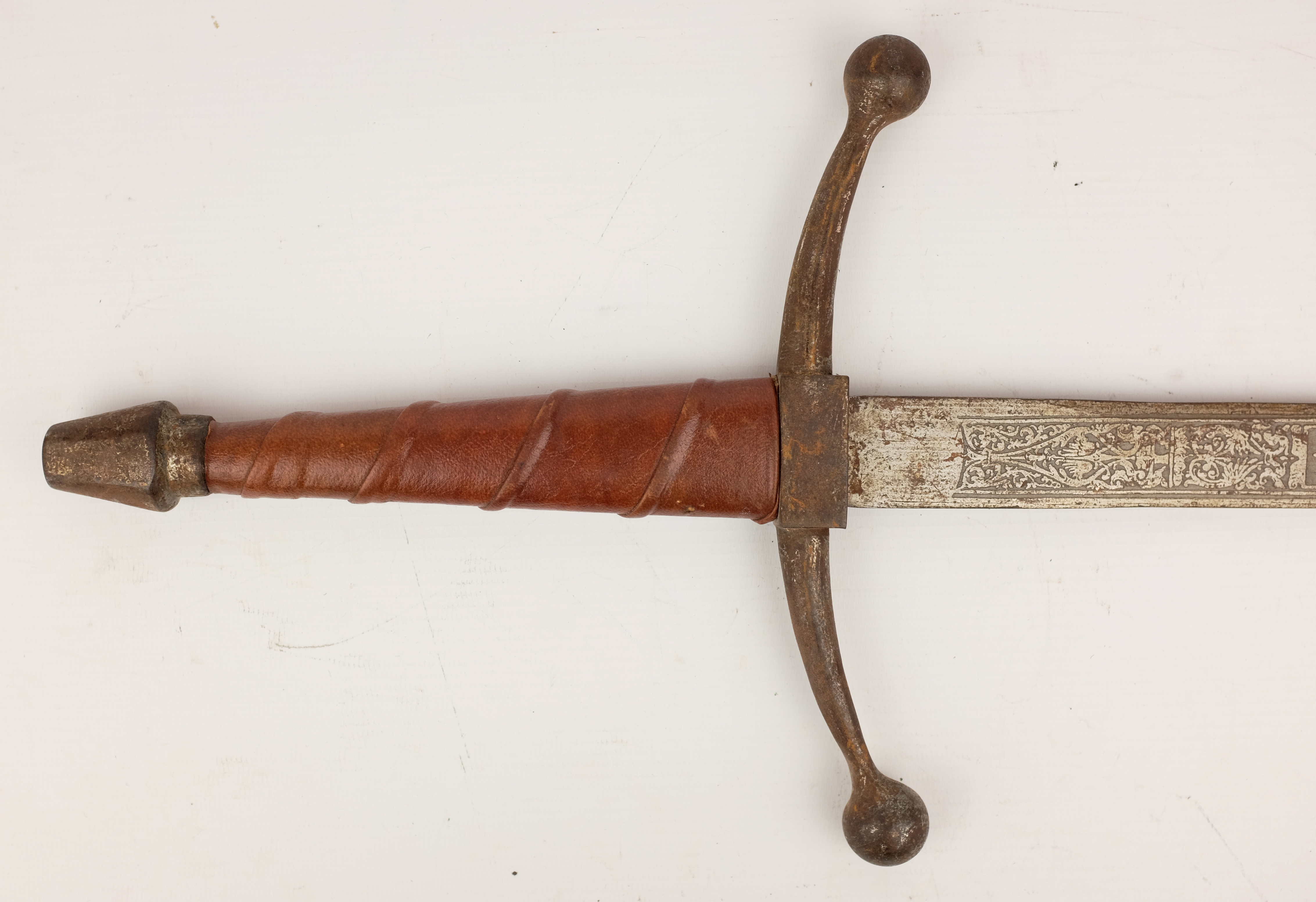 Pair of ornamental Spanish type swords with leather bound grips, 69cm