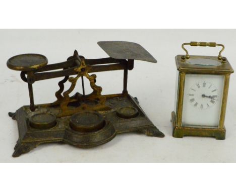 A set of brass postal scales and a c.1900 brass carriage clock, the white enamel dial set with Roman numerals (for restoratio