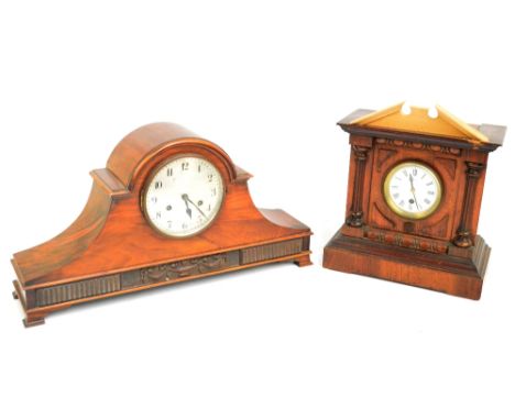 A walnut domed mantel clock, the circular silvered dial set with Roman numerals and a further mantel clock, the white enamel 