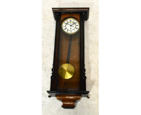 A late 19th century Vienna wall clock with turned pilaster corners, the brass edged white enamel chapter ring set with Roman 