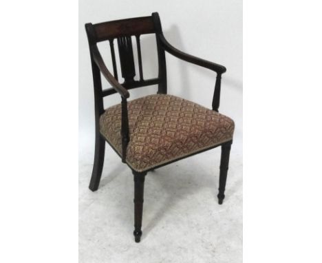 A Regency mahogany bar back elbow chair with padded stuffover seats and ring turned front legs.
