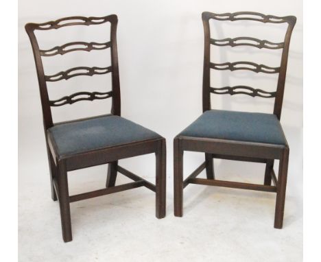 A set of seven Georgian mahogany ribbon ladder back dining chairs on chamfered square section supports (6+1).
