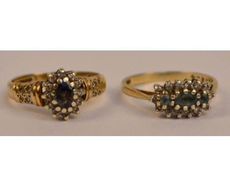 A 9ct yellow gold sapphire and diamond cluster ring, the central oval faceted stone within border of twelve tiny diamonds in 