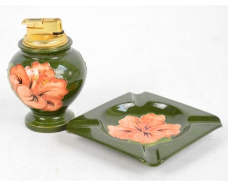 A Moorcroft "Hibiscus" pattern tubeline decorated table lighter of baluster form, height 11cm, and a matching square ashtray,