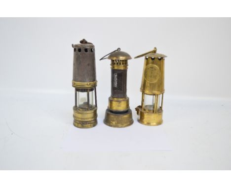 A gauze cylindrical miners' lamp, height 25cm and two others (3).