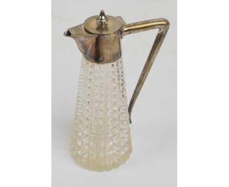 An early 20th century cut glass and silver mounted small decanter, probably Italian, the hinged lid above angled handle and t