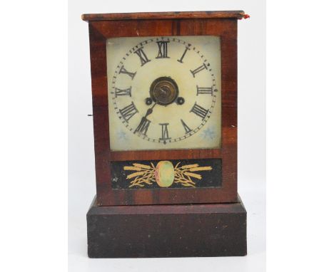 A late 19th century American mantel clock with Roman numerals to the painted dial and plinth base.