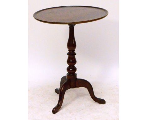 A 19th century mahogany tilt top occasional table, the circular dished top above baluster ring turned central column and thre