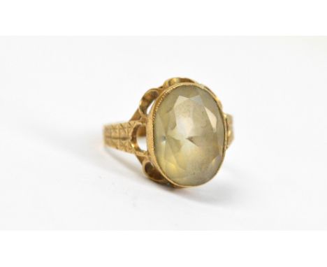 A 9ct yellow gold dress ring set with an oval champagne coloured faceted stone in a pierced gallery, size M, approx 3.6g.