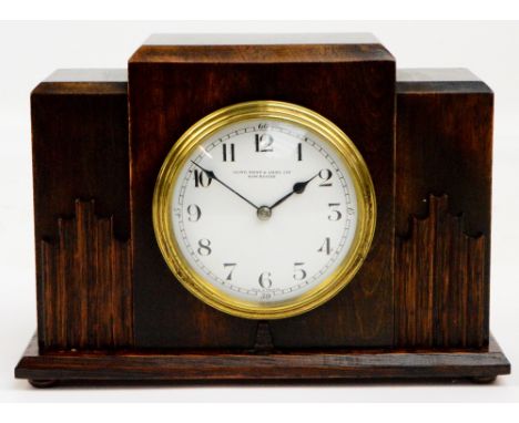 LLOYD, PAYNE & AMIEL LTD OF MANCHESTER; an early 20th century oak Art Deco style mantel clock, the circular dial set with Ara
