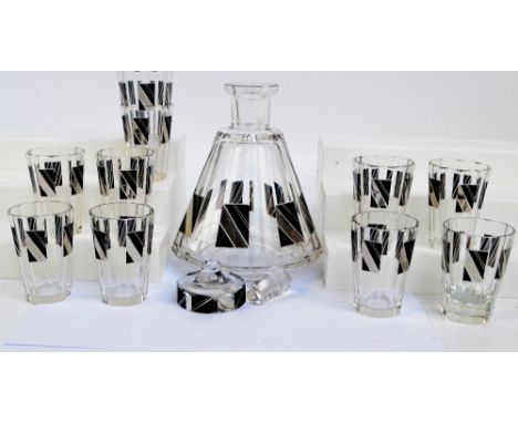 A Bohemian glass decanter of conical shape with cut side set with black and silvered panels with matching glasses. CONDITION 