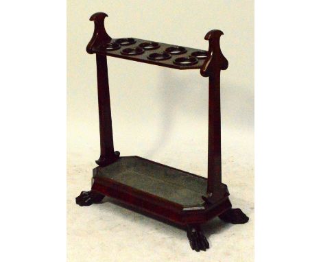 A good quality mid 19th century mahogany stick stand, the shaped end supports united by an upper platform set with eight ring