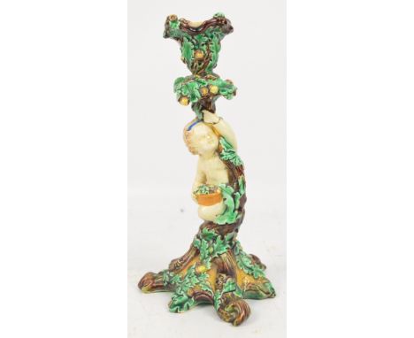 A 19th century Wedgwood majolica figural candlestick modelled as a cherubic figure at an oak tree, impressed marks to base, h