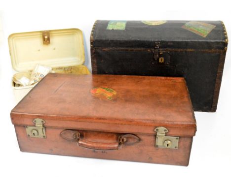 A Victorian dome topped canvas covered trunk, width 61cm, with vintage travelling stickers, a small tin example containing la