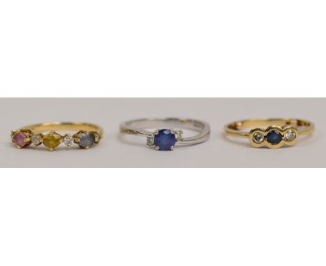 A 14ct yellow gold ring set with blue, yellow and pink oval cut sapphires alternating with four small diamonds in claw settin