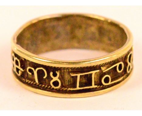 A yellow metal ring with central band set with the twelve signs of the zodiac, ring size R, approx 3.6g.