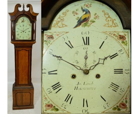 An early 19th century oak and mahogany crossbanded eight day longcase clock, the hood with broken swan neck pediment above ar