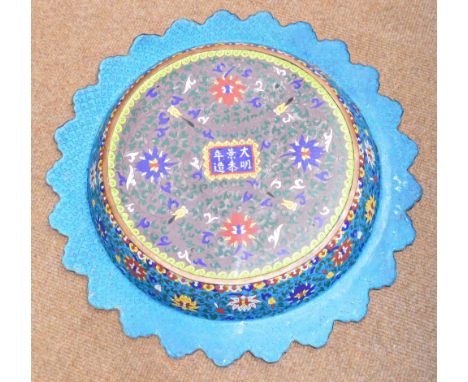 A large decorative Chinese Ming style champlevé enamel dish with shaped rim, decorated with two dragons inside a floral borde