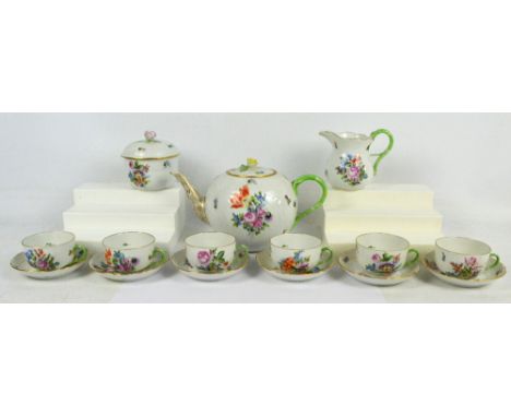 A Herend floral decorated tea set comprising large globular teapot, lidded circular sugar bowl, jug, six cups and six saucers