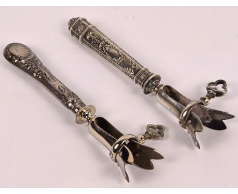 Two French silver sheath handled ham bone holders, one with an octagonal decoration of scrolling foliage with vacant cartouch