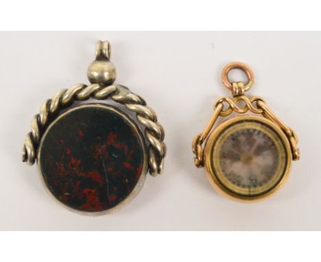 A 9ct yellow gold swivel fob with compass to one side and hardstone to the other and a larger hallmarked silver swivel fob wi